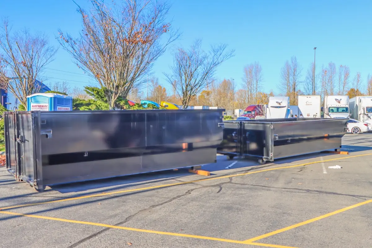Professional dumpster rental service with roll-off container on residential driveway in Sikeston